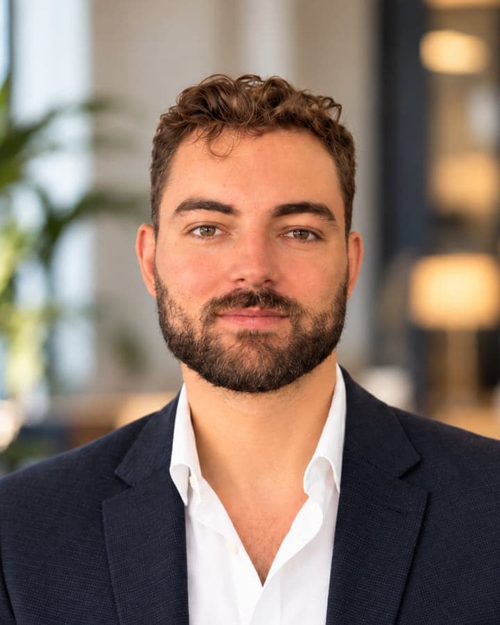 Edward, founder of Horizon Labs, smiling in a navy blazer and white shirt